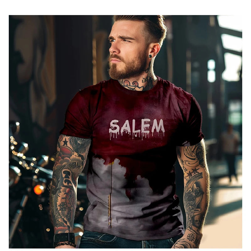 Man wearing a maroon t-shirt with 'SALEM' printed on it, standing outdoors.