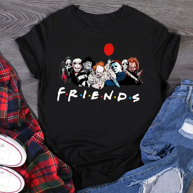 Black t-shirt with 'Friends' graphic featuring horror movie characters on a wooden surface.
