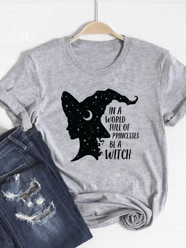 Gray t-shirt with witch graphic and text on a hanger with jeans below