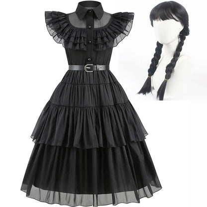 Black dress with ruffled collar and sheer layers, paired with a black wig on a mannequin head.