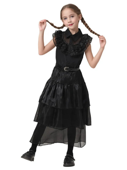 Young girl wearing a black dress with ruffled details on a white background