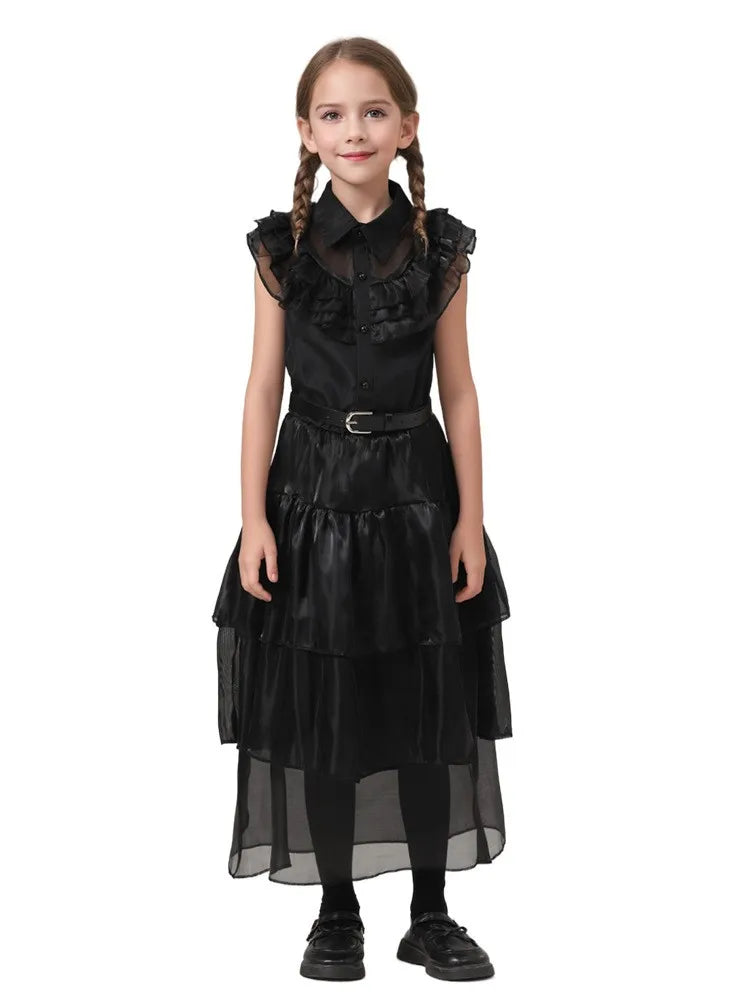 Girl wearing a black dress with ruffled details on a white background