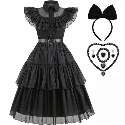 Black dress with ruffled collar, black headband with bow, and black jewelry set on a white background