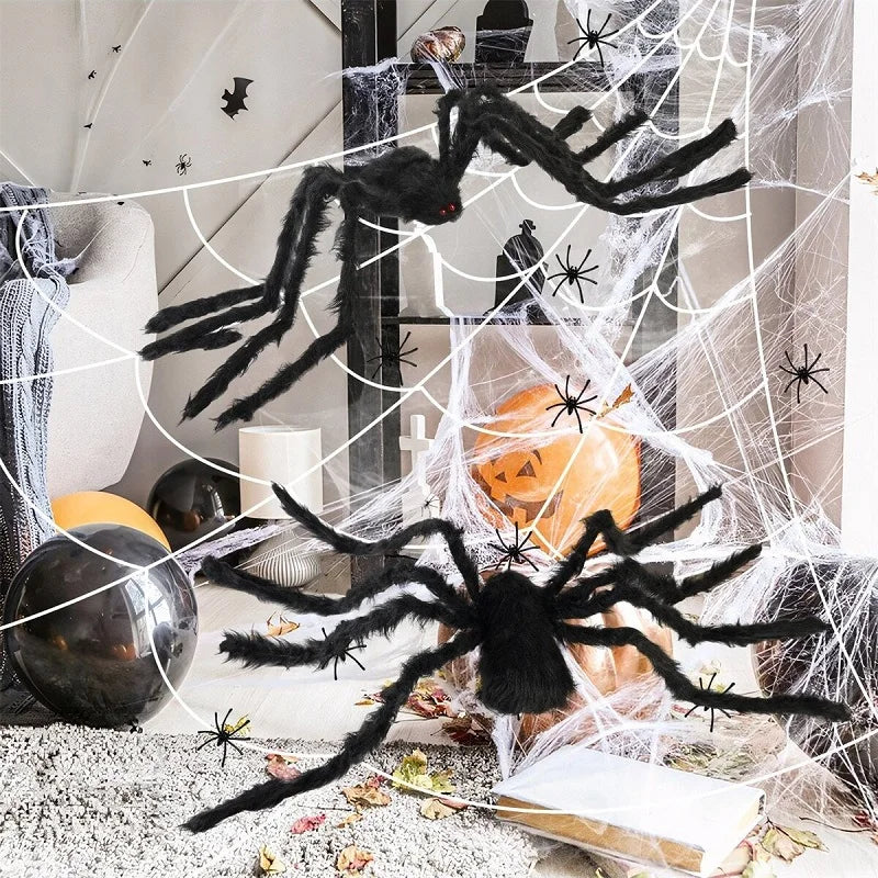 Halloween decorations with large black spiders and spider webs.