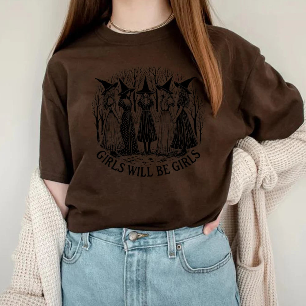Person wearing a brown sweatshirt with a graphic design and text, standing against a neutral background.