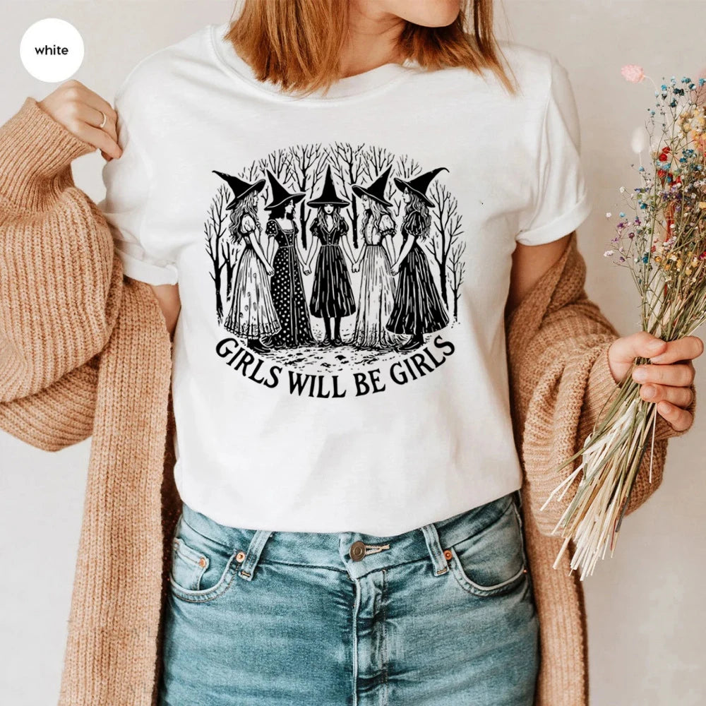 Person wearing a white t-shirt with a graphic design and text, holding dried flowers.