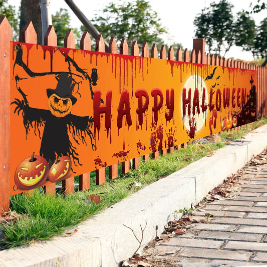 Halloween-themed decorative sign on a wooden fence with pumpkins and a scarecrow.