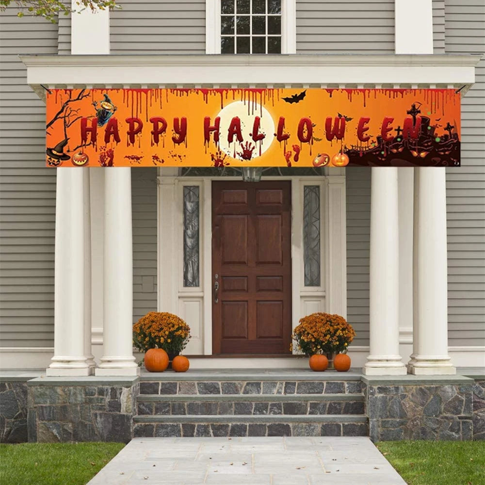 Halloween banner with pumpkins, ghosts, and bats on an orange background above a house entrance.