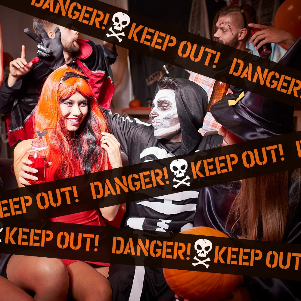 People in Halloween costumes surrounded by 'Keep Out!' tape with a skull symbol.