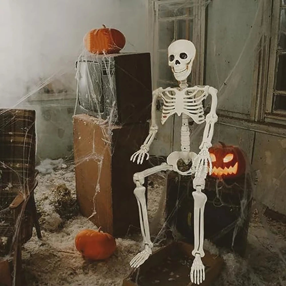 Halloween-themed room with a skeleton, pumpkins, and cobwebs.