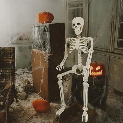 Halloween-themed room with a skeleton, pumpkins, and cobwebs.