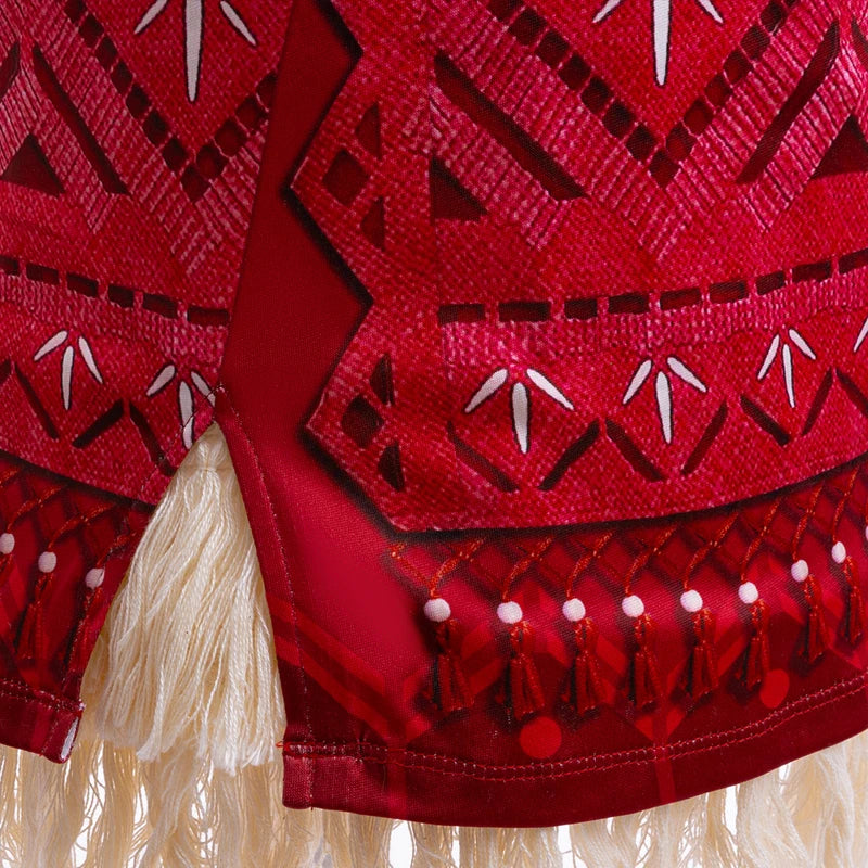 Red fabric with intricate white patterns and tassels on a beige background