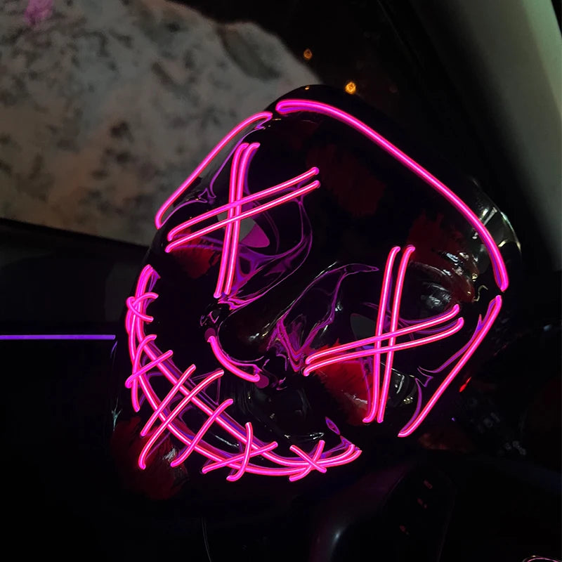 Neon pink LED mask on a dark background