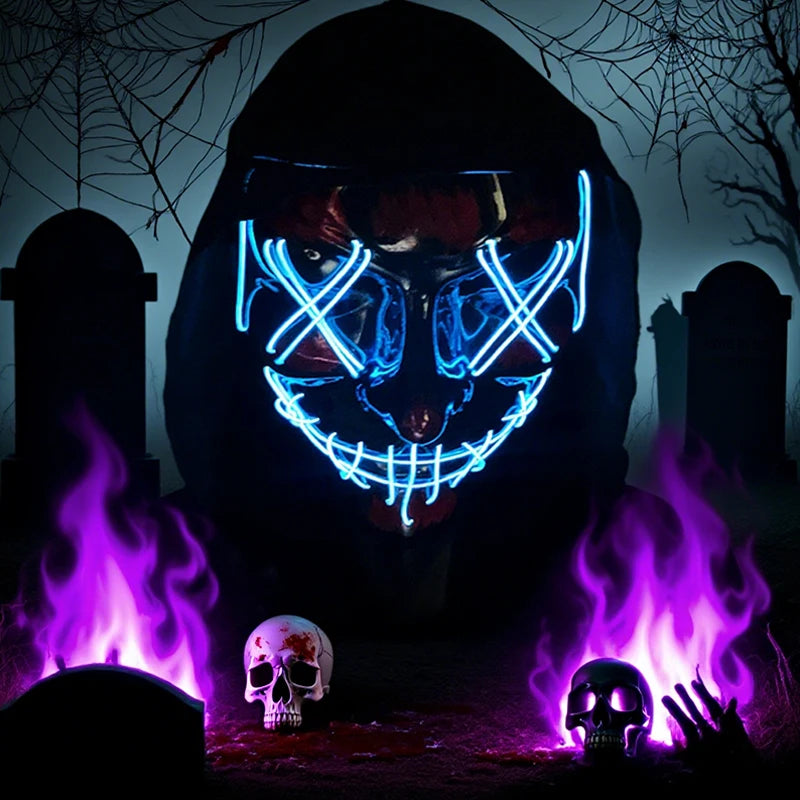 Person wearing a LED mask with blue lights in a dark, Halloween-themed setting with flames and skulls.