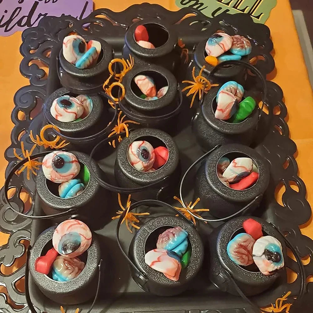 Halloween-themed candy arrangement with colorful eyeball treats on a decorative stand.