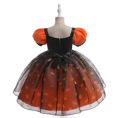 Orange and black dress with pumpkin pattern on a mannequin against a white background