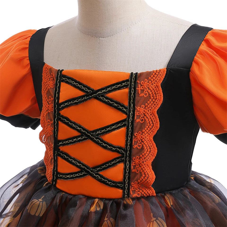 Orange and black dress with lace details on a mannequin against a white background
