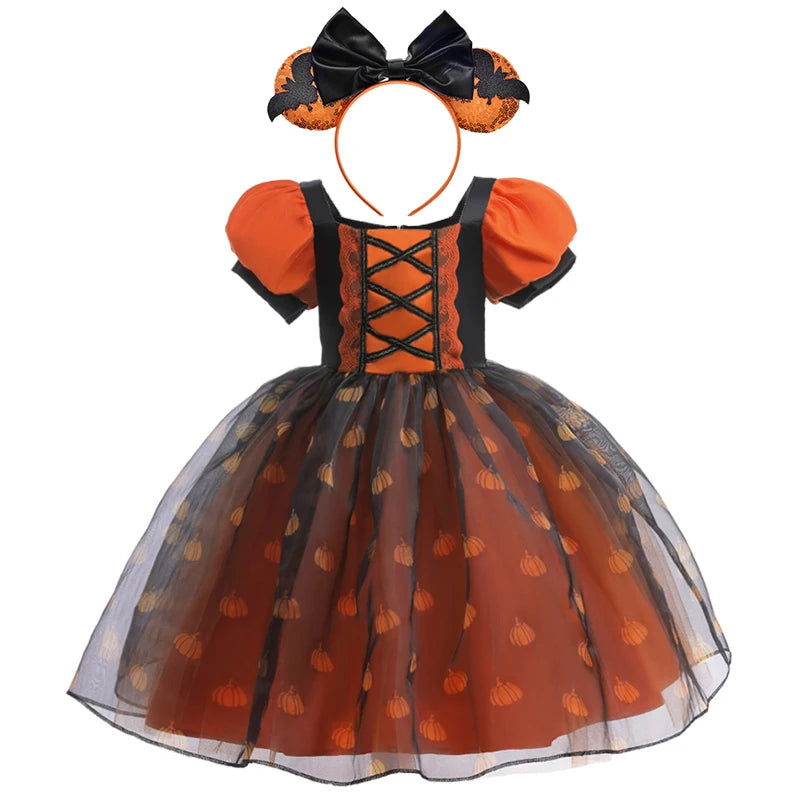 Halloween-themed dress with pumpkin pattern and matching headband on a white background