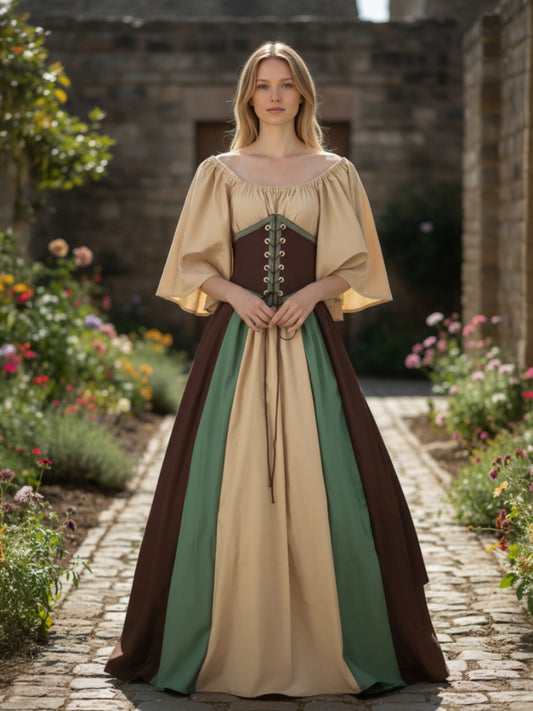 Woman in a medieval-style dress standing in a garden with stone walls.
