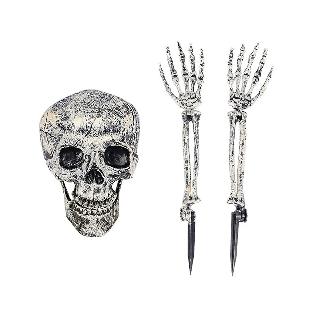 Skull-shaped object with two skeleton hands holding stakes on a white background