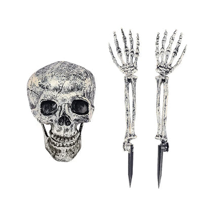 Skull-shaped object with two skeleton hands holding stakes on a white background