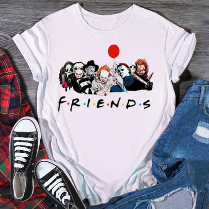 White t-shirt with horror character design and 'FRIENDS' text, surrounded by shoes and jeans on a wooden surface.