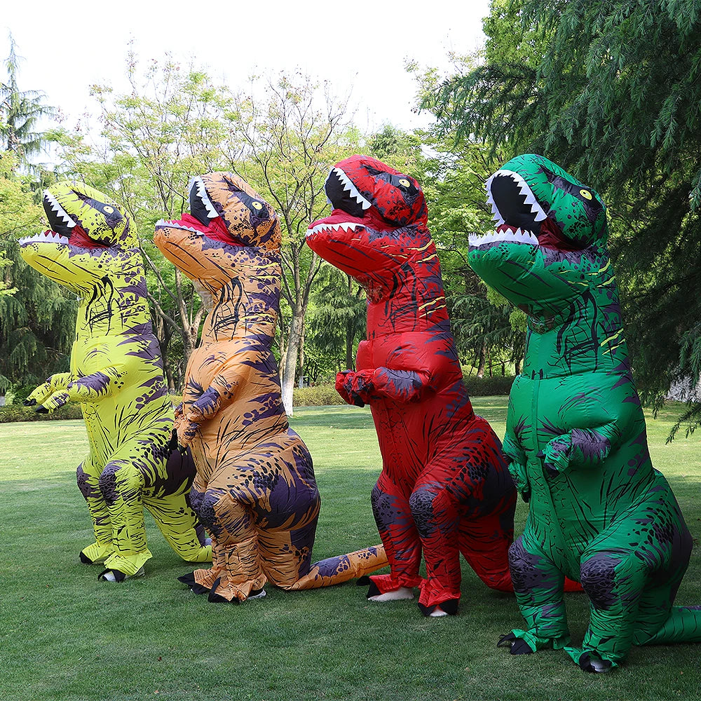 Four inflatable dinosaur costumes in different colors on a grassy field.