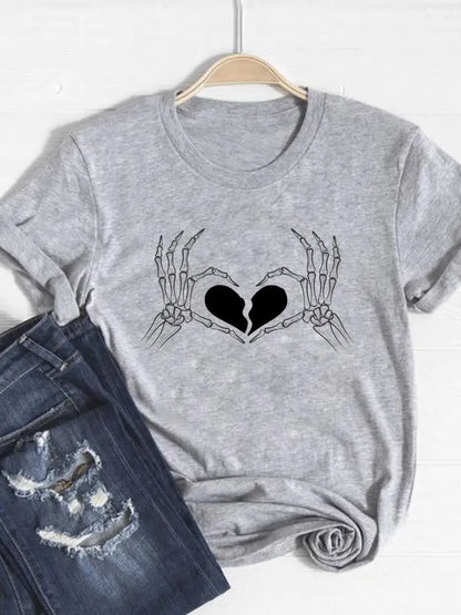 Gray t-shirt with skeleton hands holding a heart design, paired with jeans on a white background.