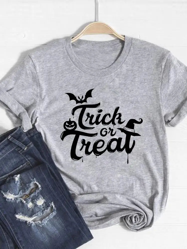 Gray t-shirt with 'Trick or Treat' text on a hanger with jeans below.