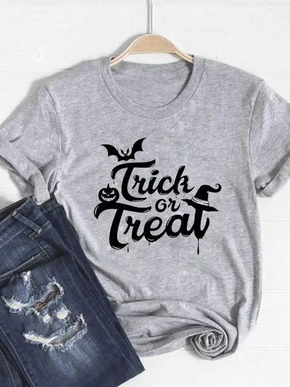 Gray t-shirt with 'Trick or Treat' text on a hanger with jeans below.