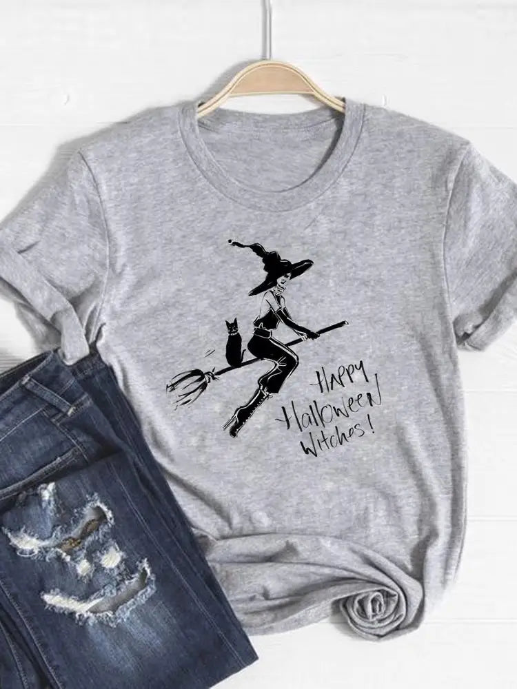 Gray t-shirt with witch graphic and 'Happy Halloween Witches!' text on a hanger with jeans below.
