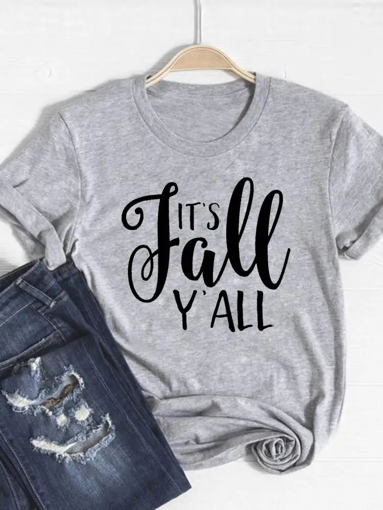 Gray t-shirt with 'It's Fall Y'all' text on a hanger with jeans below.