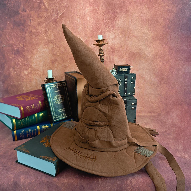 Brown wizard hat with books and a candle on a textured surface