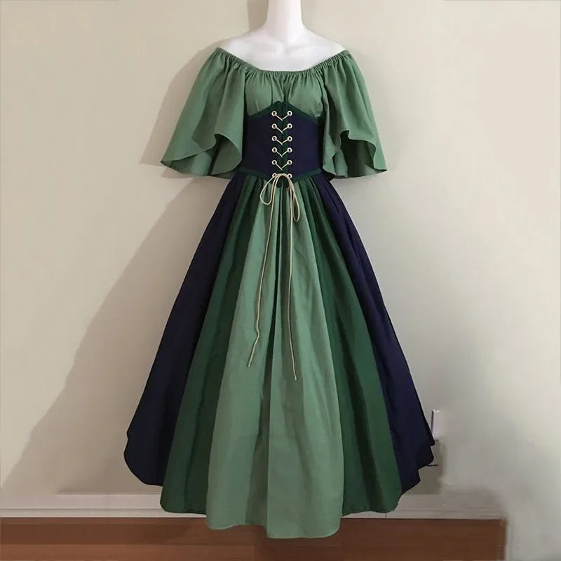 Green and navy dress on a mannequin against a plain background