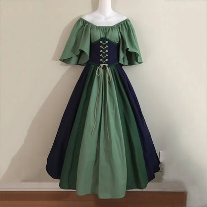 Green and navy dress on a mannequin against a plain background
