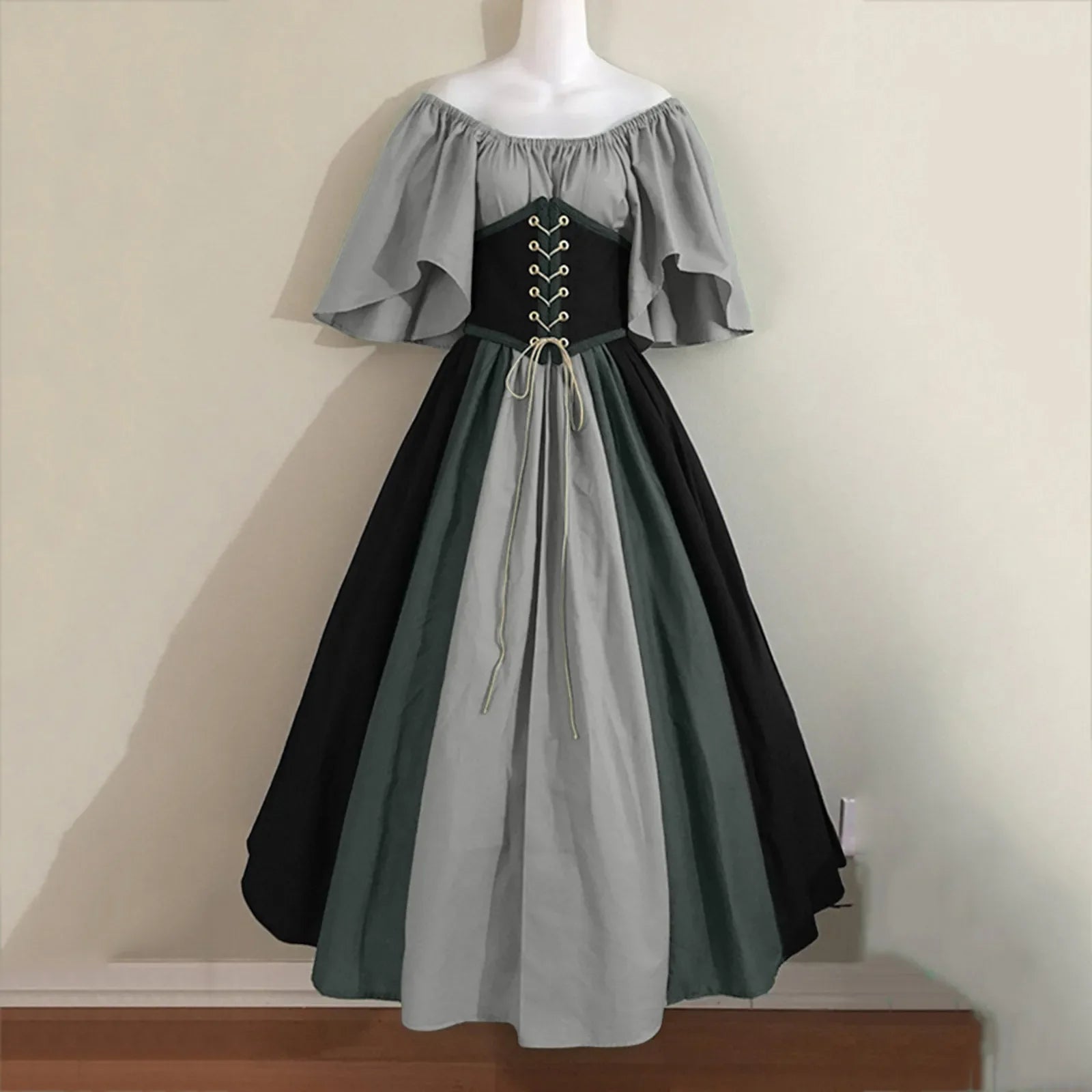 Two-tone dress with gray and black colors on a mannequin against a plain background.